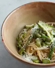 Flavorful spicy Asian noodles with tender asparagus and a sprinkle of sesame for a savory, crunchy bite.